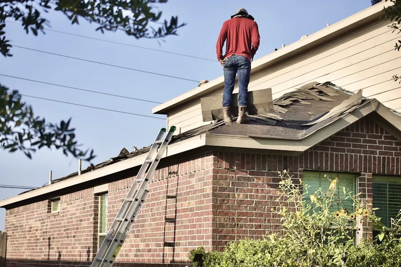 Professional roofer working on a residential roof in Wood Bridge Green
